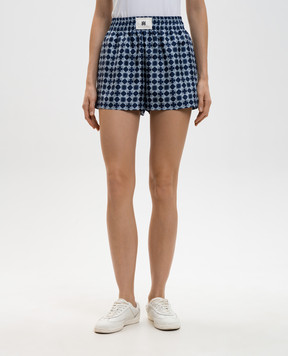 AMIRI Синие шорты из шелка в принт монограммы логотипа AWSHCA1021